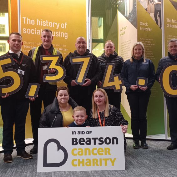 Staff from Wheatley Group, Seasonal Produce and Fraser C Robb holding numbers reading £5,374.00