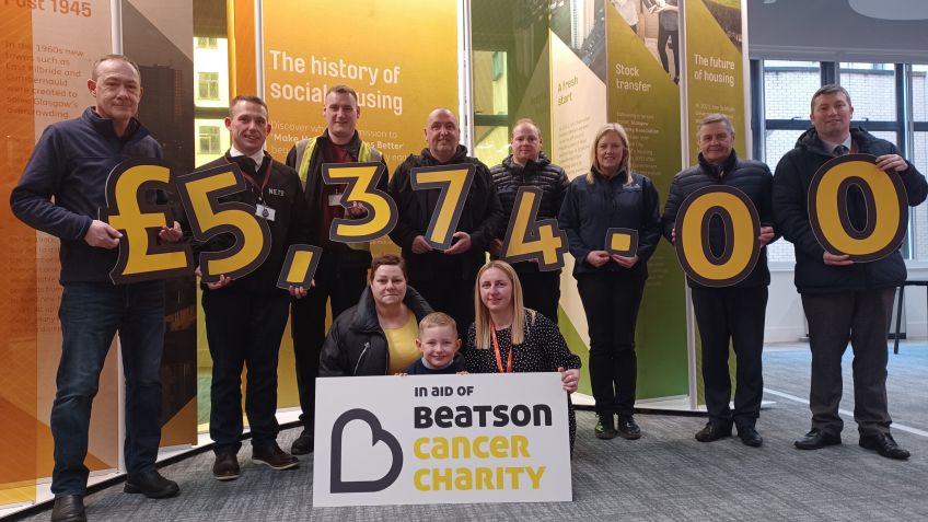 Staff from Wheatley Group, Seasonal Produce and Fraser C Robb holding numbers reading £5,374.00