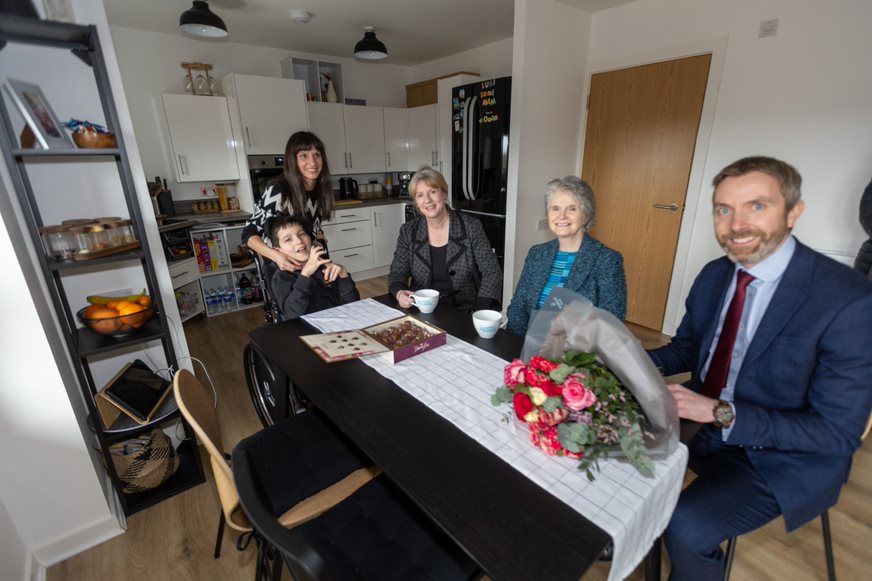 Stanislava and Lubomir Petrova welcome Cab Sec Shona Robison, Wheatley Chair Jo Armstrong and Wheatley Chief Exec Steven Henderson into their new home in Queens Quay  