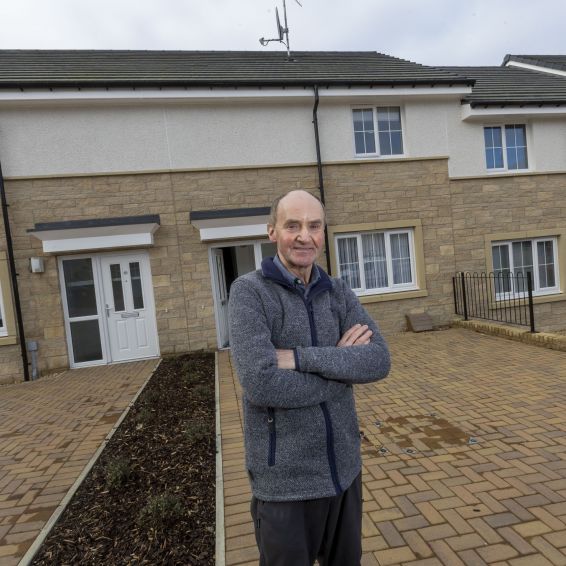 Loretto tenant standing outside his home