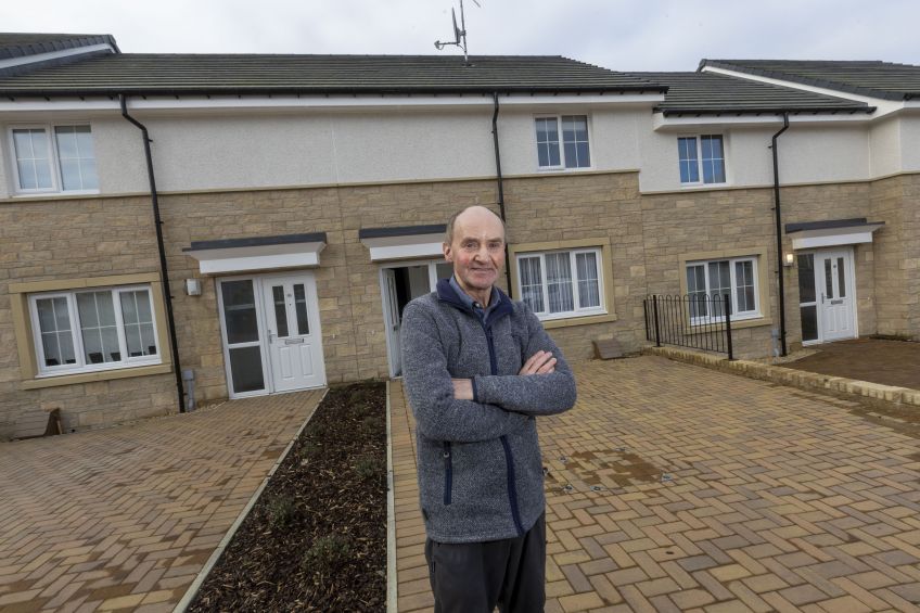 Loretto tenant standing outside his home