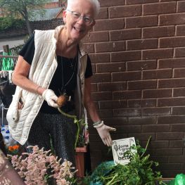 Mary shows her vegetables she has grown in the community garden