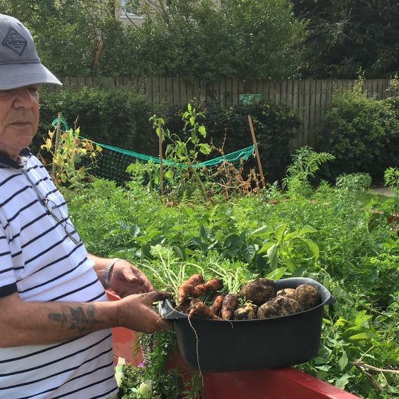 Hugh showing his produce from the garden