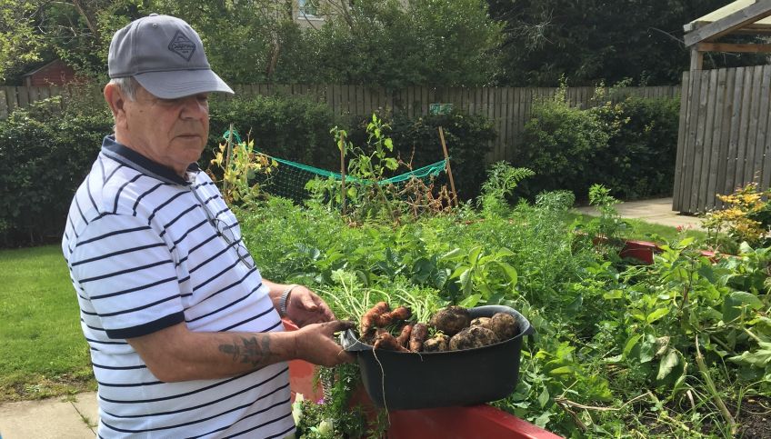 Hugh showing his produce from the garden