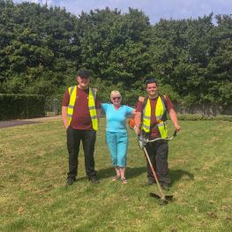 Wheatley Homes Glasgow customer Marion standing with two staff from NETs