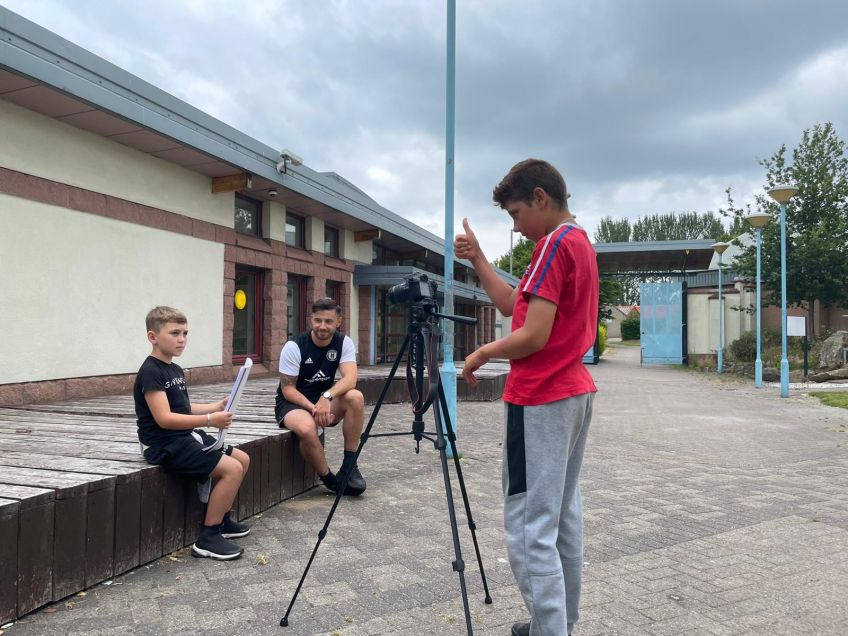 Dominik and Harrison learning to film and edit during a workshop in Paisley.