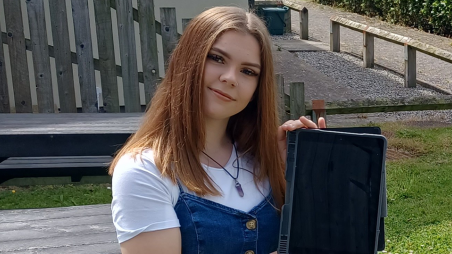 DGHP customer Kianna holding an iPad