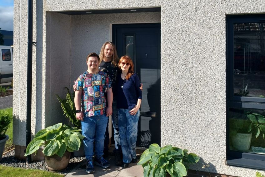 Merek, Aneta and Jakub outside their new home